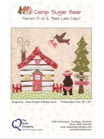 Quilt pattern cover for 'Bare Lake Cabin' featuring a cabin, bear, and Christmas tree.