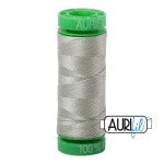 Spool of green thread with a visible brand logo on a white background