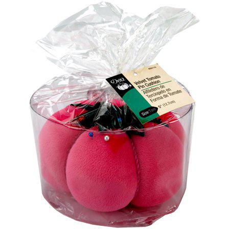 Pink velvety tomato-shaped pet toys in clear packaging with a label.
