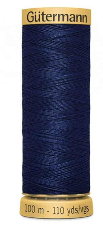Spool of Gutermann thread in navy blue on a white background