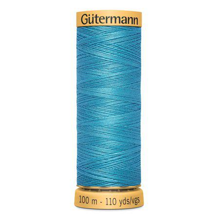 Spool of Gutermann thread on a white background