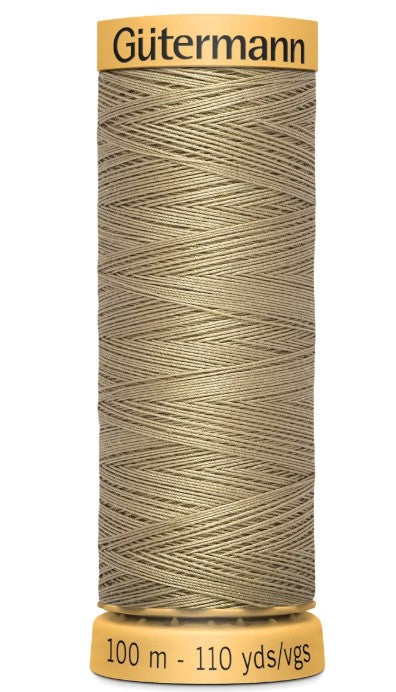 Spool of Gutermann thread on a white background