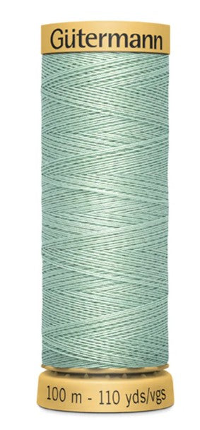 Spool of Gutermann thread in light blue color on a white background