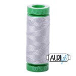 Spool of white thread with green accents on a white background