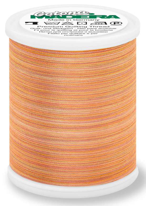 Spool of Madeira Cotona 50wt thread in Sunset, color 512