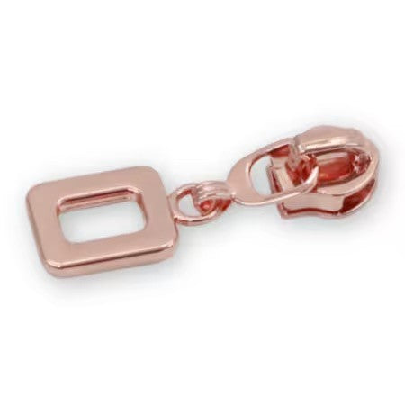 Four #5 rounded rectangle zipper pulls rose gold finish bag hardware