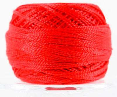 Red spool of thread on a white background