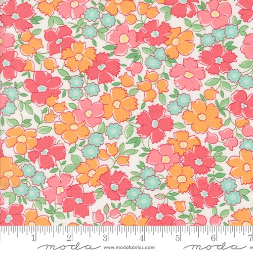 Floral fabric pattern with a ruler at the bottom for scale, featuring pink, orange, and green flowers on a white background.