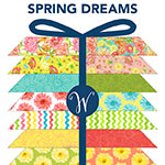 Packaged quilt with colorful patterns and 'Spring Dreams' text on a white background