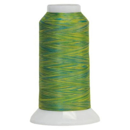 Spool of green and yellow thread on a white background