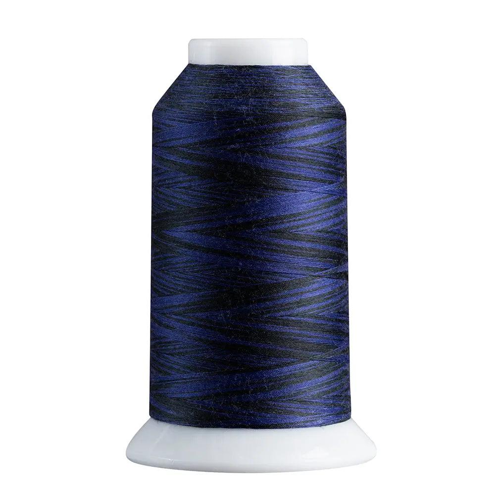 Spool of blue thread on a white background