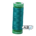 Green spool of thread with 'Aurora' branding on a white background
