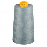 Spool of gray thread with a yellow cap on a white background