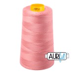 Pink spool of thread with a brand label on a white background