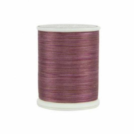 Spool of purple thread on a white background