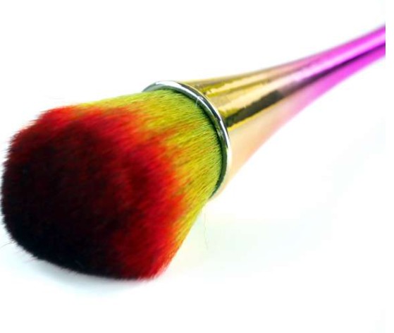 Makeup brush with multicolored bristles on a white background
