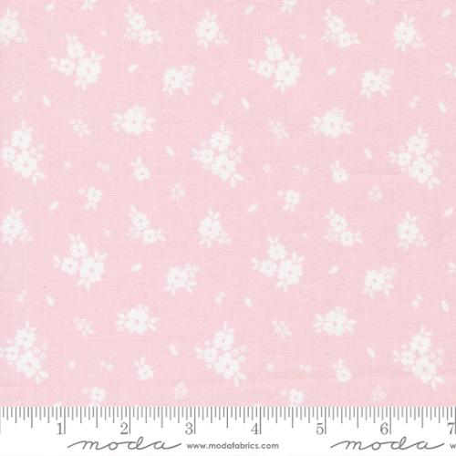 White floral pattern on a pink background with a ruler at the bottom