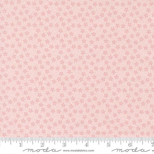 Pink floral pattern fabric with a ruler at the bottom