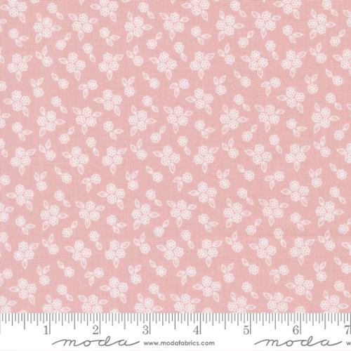 Pink fabric with white floral pattern and Moda label
