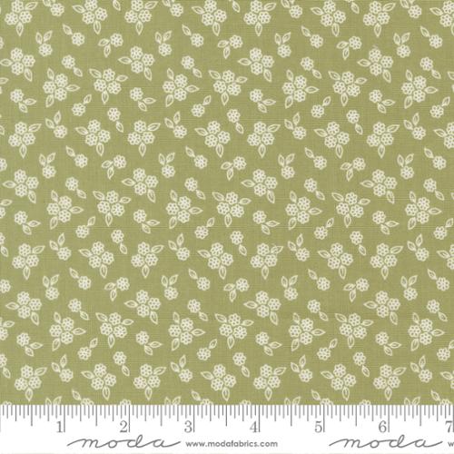 Floral pattern fabric with a ruler at the bottom on a green background