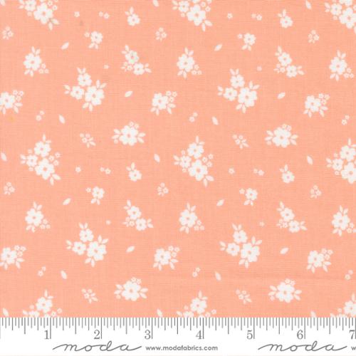 White floral pattern on a peach background with Moda label.