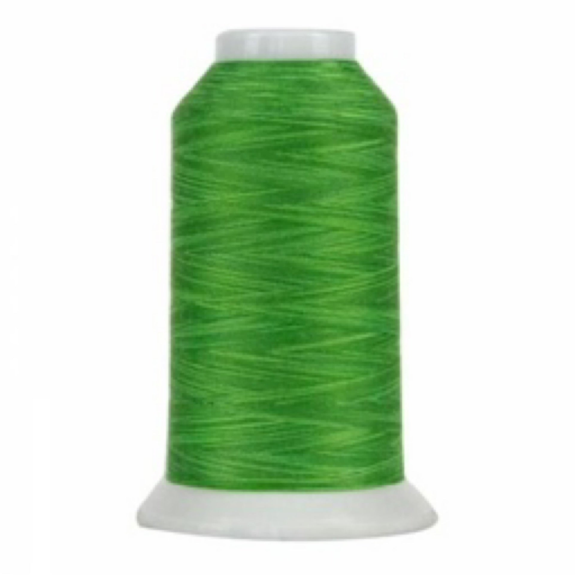 Spool of green thread on a white background
