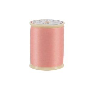 Spool of pink thread on a white background
