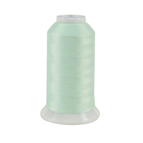 Spool of light green thread on a white background