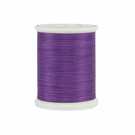Spool of purple thread on a white background