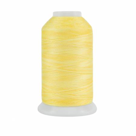 Spool of yellow thread on a white background