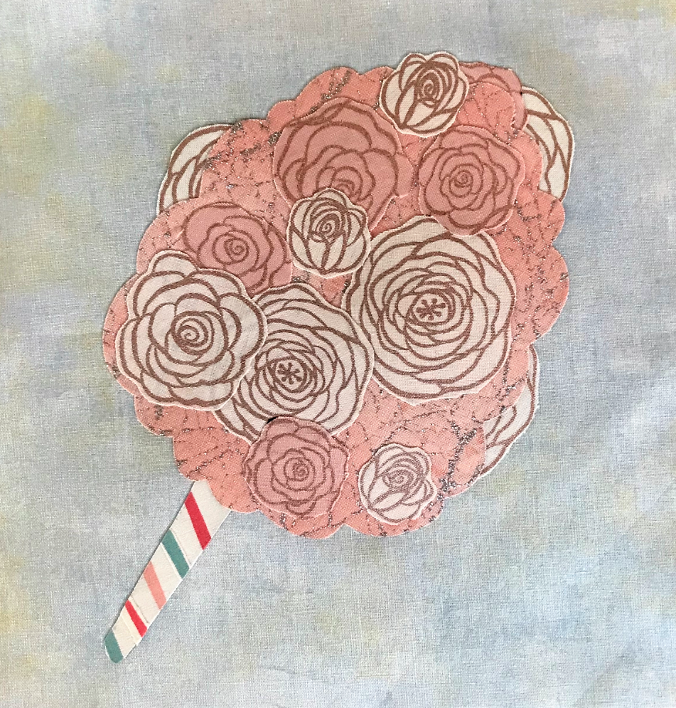 Decorative lollipop with rose designs on a textured background