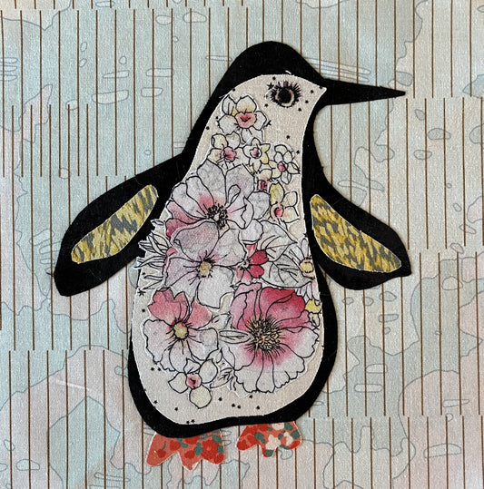Decorative penguin with floral patterns on a wooden background