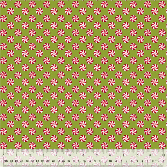 Pattern of red and white peppermint swirls on a green background with a ruler at the bottom.