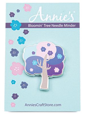 Tree-shaped needle minder on a blue card with floral designs and 'Annie's' branding.
