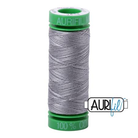 Spool of Aurifil thread with green label on a white background