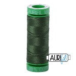 Green spool of thread with 'AURUM' branding on a white background