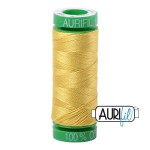Spool of yellow thread with a brand label on a white background