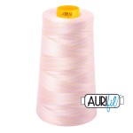 Pink spool of thread with a yellow label on a white background
