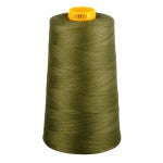 Spool of green thread with a yellow cap on a white background