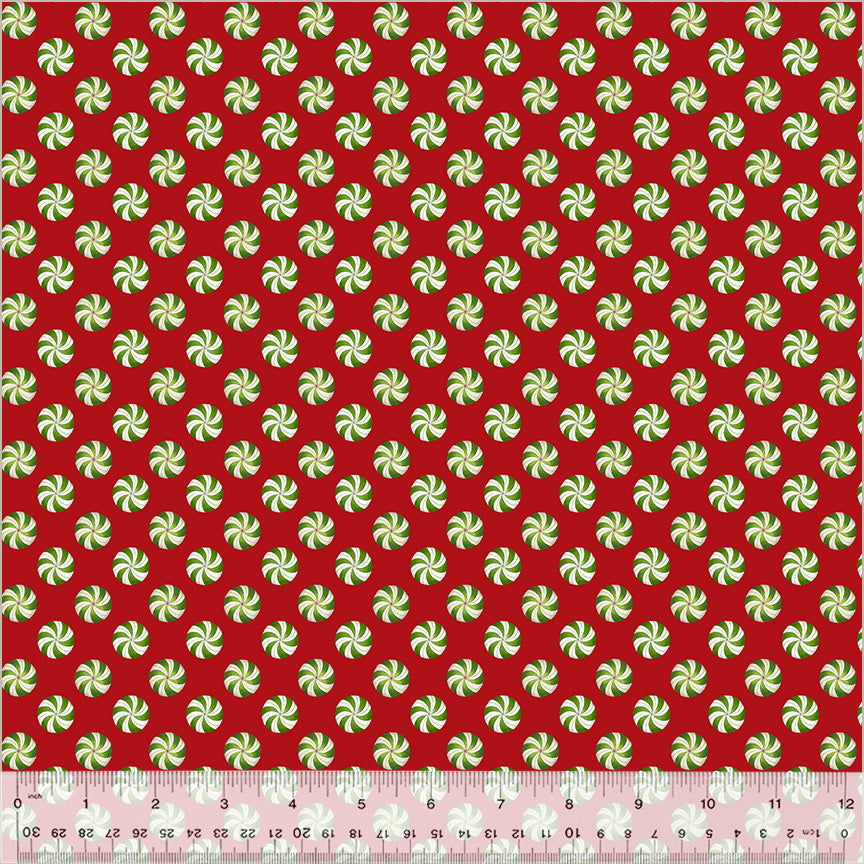 Red fabric with evenly spaced green-and-white peppermint candy swirls.
