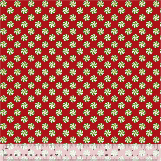 Red fabric with evenly spaced green-and-white peppermint candy swirls.