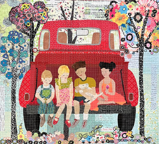 Quilt with a red bus and children sitting on it, surrounded by colorful flowers and patterns.