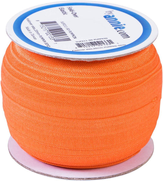 Spool of orange ribbon with a label on a white background