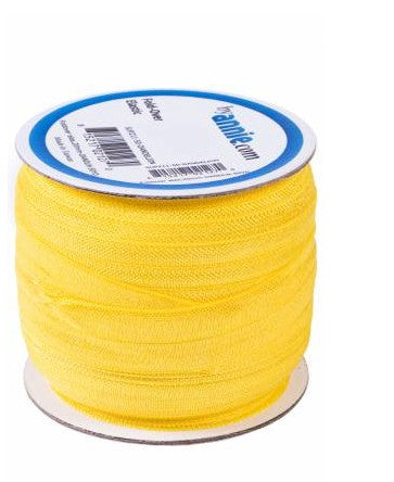 Spool of yellow thread with a blue label on a white background