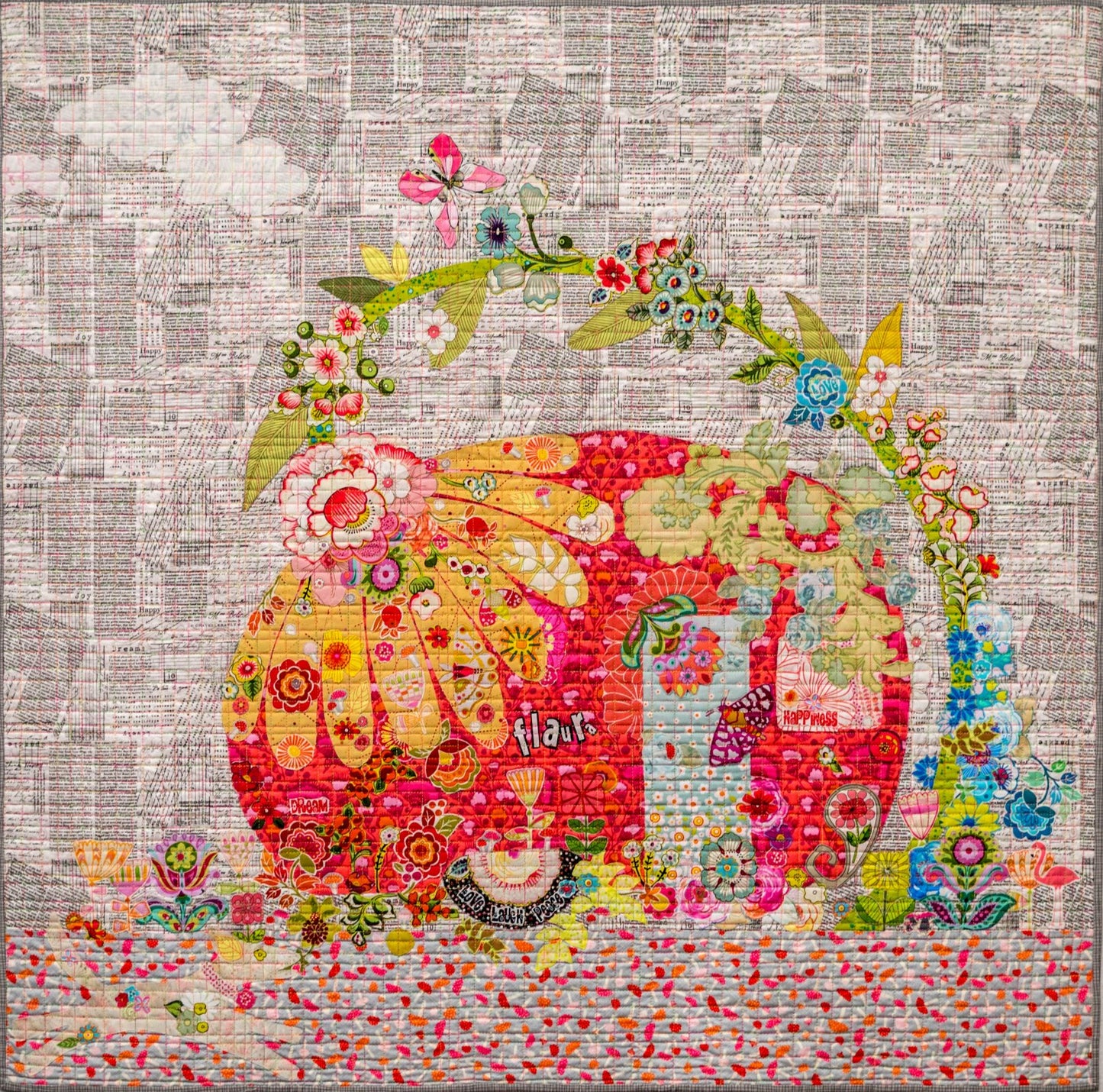 Flaura vintage trailer collage quilt pattern by Laura Heine featuring playful travel themed fabric collage design