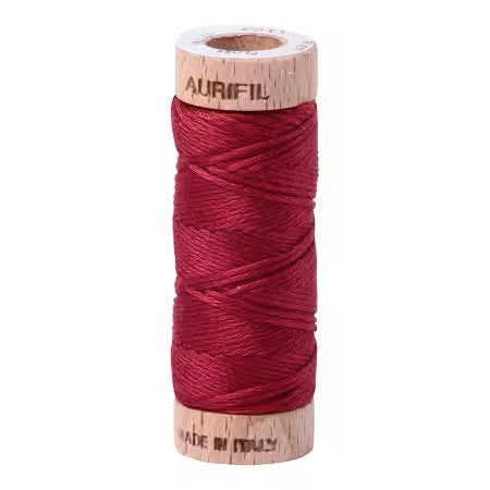 Spool of red thread with 'Aurifil' branding on a white background