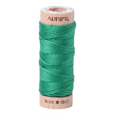 Spool of green thread with 'Aurifil' branding on a white background