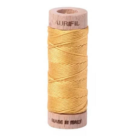 Spool of Aurifil thread on a white background