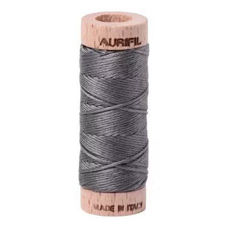 Spool of Aurifil thread on a white background