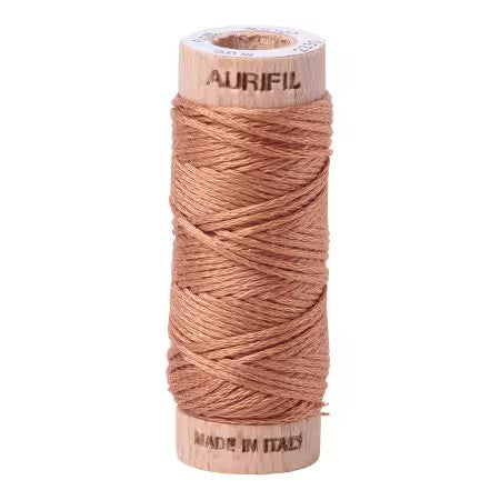 Spool of Aurifil thread on a white background